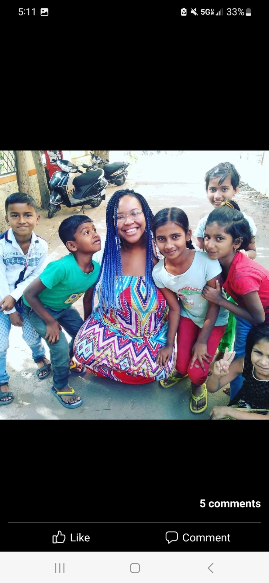 Renada surrounded by smiling children